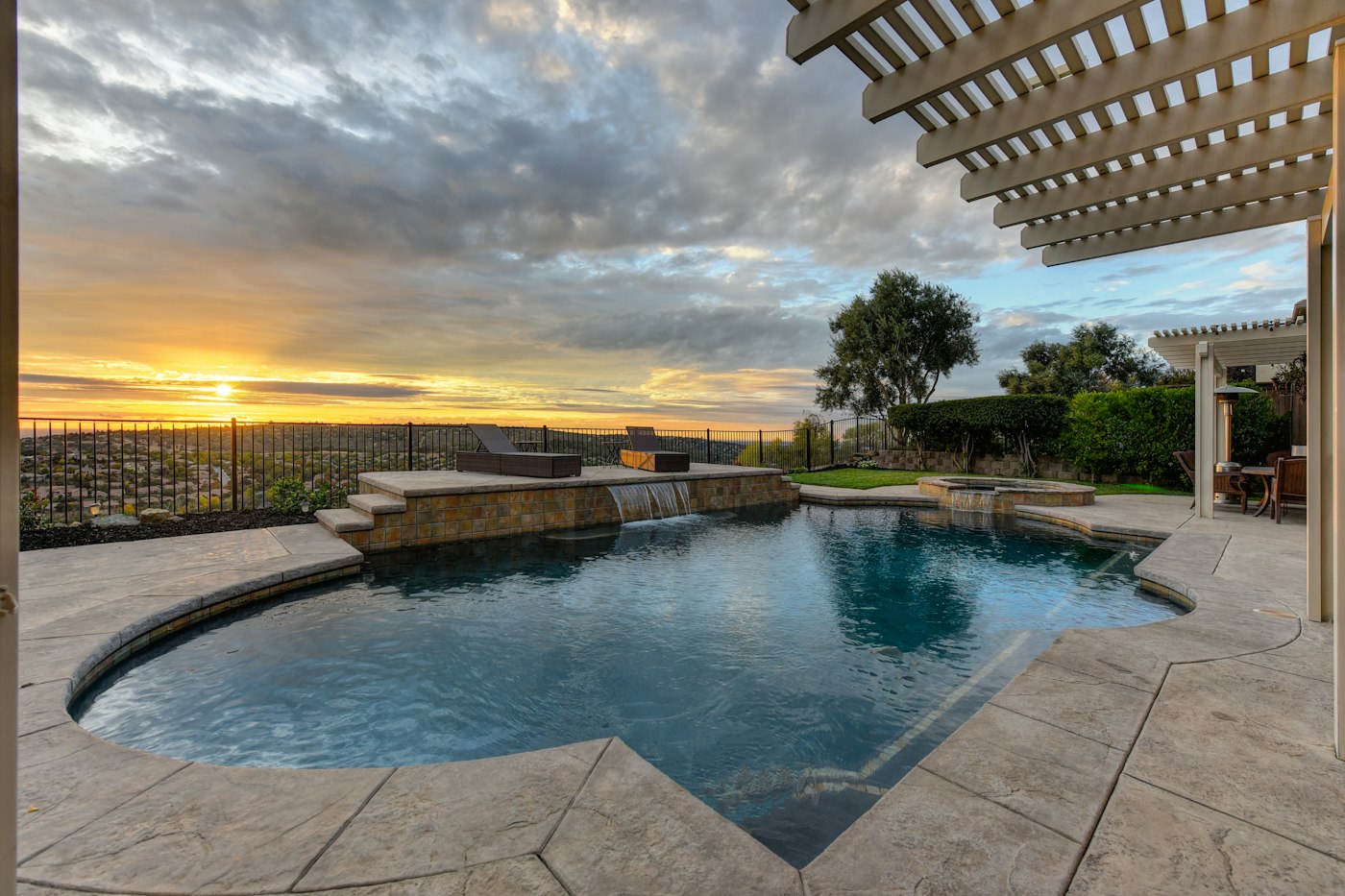 Sunset pool with built-in hot tub and pergola